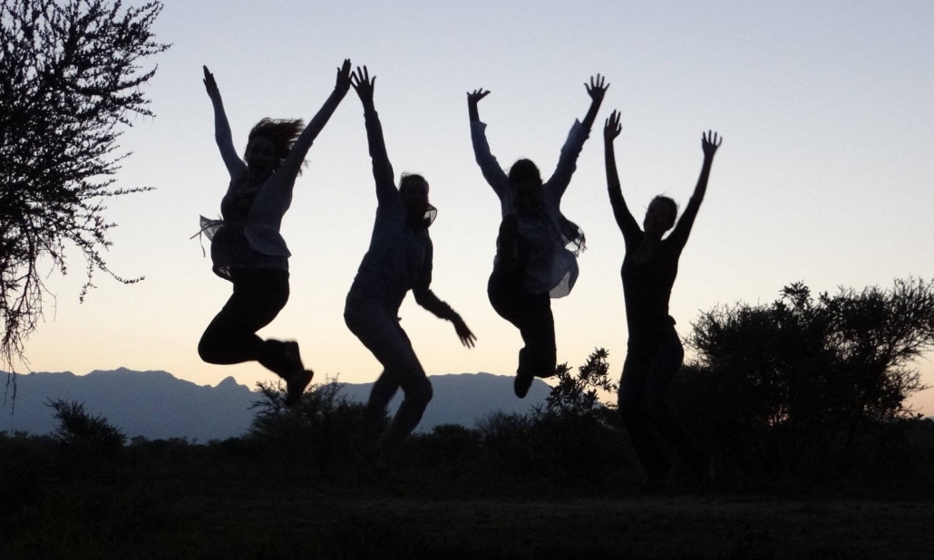Silhoutes jumping high, communicate with joy